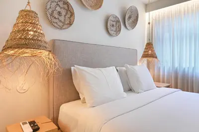 a bedroom with a bed and a chair and a window at Sleep in Office by ON Apartments in Porto