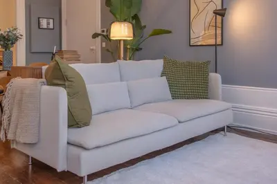 a white couch sitting in a living room at Historic Porto Stay, Classic Details, City Life in Porto