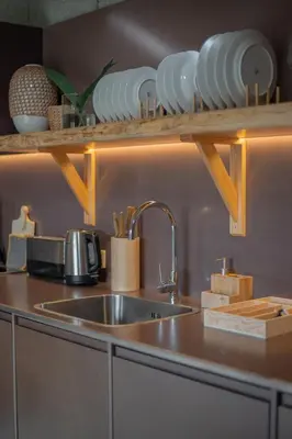 a kitchen counter with a sink and plates on a shelf at Hut E, Cabana in Town in Porto
