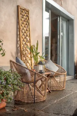 three wicker chairs and a table on a patio at Hut E, Cabana in Town in Porto