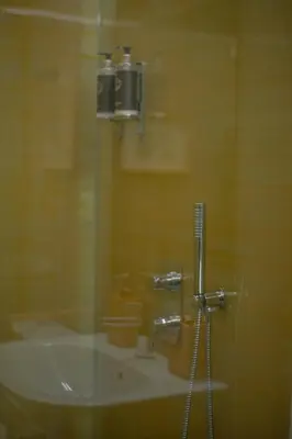 a glass window of a bathroom with a sink at Hut E, Cabana in Town in Porto