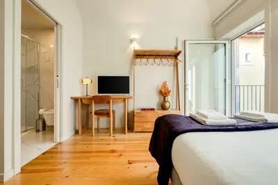 a bedroom with a bed and a desk and a television at Luxury Style 5 with AC Downtown Porto near Metro in Porto