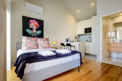 a bedroom with a bed and a kitchen at Luxury Style 5 with AC Downtown Porto near Metro in Porto