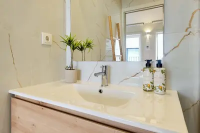 a bathroom with a sink and a mirror at Luxury Style 5 with AC Downtown Porto near Metro in Porto