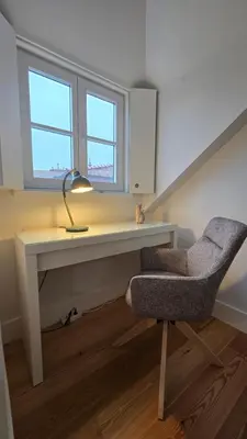 a rug in a room with a white wall at Upper Story 1BR AC and Workspace in Porto