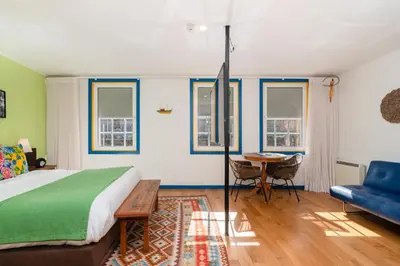 a bedroom with a bed and a table and chairs at Miragaia House in Porto