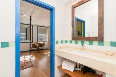 a bathroom with a sink and a mirror at Miragaia House in Porto