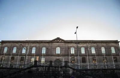 a large building with a flag on top of it at Miragaia House in Porto