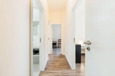 a hallway with white walls and a white door at GuestReady - Cosy family home in the Bonfim area in Porto