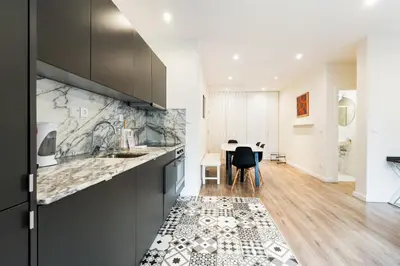 a kitchen with a counter and a dining room at GuestReady - Cosy family home in the Bonfim area in Porto