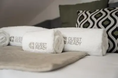 a pile of towels sitting on top of a bed at GuestReady - Charming cosy home in Porto