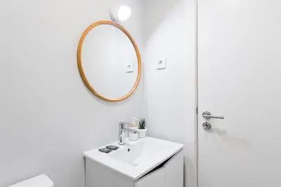 a bathroom with a sink and a mirror at GuestReady - Charming cosy home in Porto