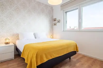 a bedroom with a bed with a yellow blanket at Violet House by LovelyStay in Vila Nova de Gaia