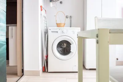 a washer and dryer in a laundry room at Violet House by LovelyStay in Vila Nova de Gaia