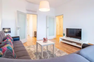 a living room with a couch and a tv at Violet House by LovelyStay in Vila Nova de Gaia