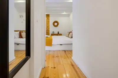 a bedroom with a bed and a mirror at Cozy Loft w Poll Near Porto Cellars in Vila Nova de Gaia