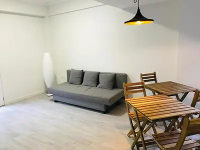 a living room with a couch and a table and chairs at Classic Freitas in Porto