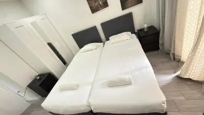 a bedroom with a white bed with two pillows at Classic Freitas in Porto