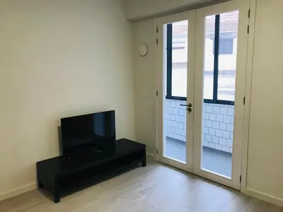 a living room with a television and a door at Classic Freitas in Porto