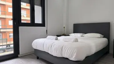 a large white bed in a room with a window at Classic Freitas in Porto