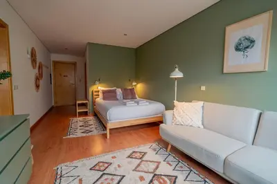 a bedroom with a bed with a lamp and a rug at Green Studio near Metro, Cedofeita, Porto in Porto