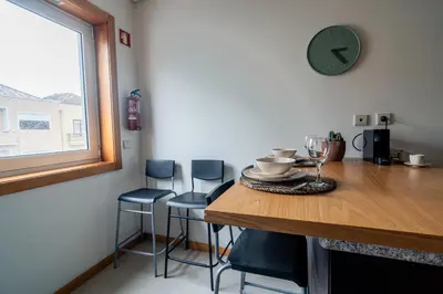 a dresser with a television and a potted plant on it at Green Studio near Metro, Cedofeita, Porto in Porto