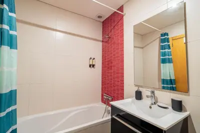 a bathroom with a sink and a tub and a mirror at Green Studio near Metro, Cedofeita, Porto in Porto