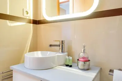 a bathroom with a white sink and a mirror at 2 Bdr Guadiana House Garden Metro Station 2min in Porto
