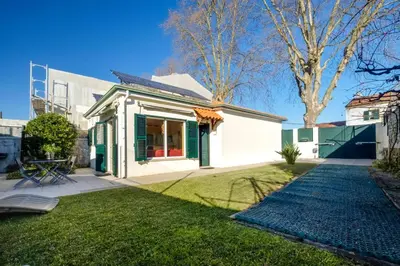a house with a green door and a yard at 2 Bdr Guadiana House Garden Metro Station 2min in Porto