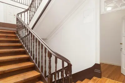 a staircase in a home with white walls and wooden floors at Belly Angel - Porto Historic Center in Porto