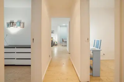 a hallway leading to a living room with a table at Porto Window House by Vacationy in Bandeira