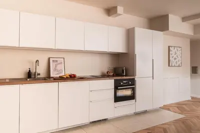 a white kitchen with white cabinets and an oven at Apartment Nunno in Porto
