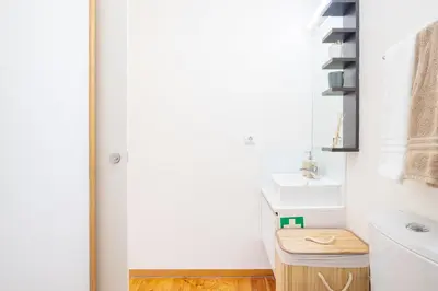 a bathroom with a sink and a toilet at The Cozy Loft in Porto