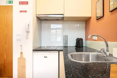 a kitchen with a sink and a counter top at The Cozy Loft in Porto