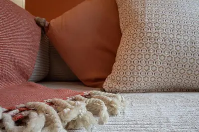 a pile of rope laying on a bed with pillows at The Cozy Loft in Porto