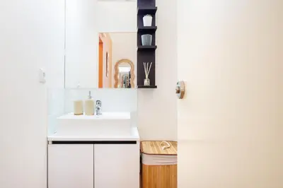 a kitchen with white cabinets and a sink at The Cozy Loft in Porto