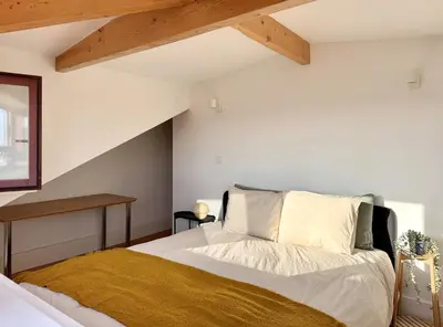 a bedroom with a bed and a wooden ceiling at Sol Do Porto - 2 bed Penthouse Luis Bridge view in Porto