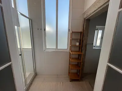 a bathroom with a window and a ladder in it at Studio in a typical Porto house in Porto