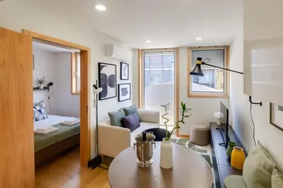 a living room with a couch and a table at Camoes Apartment with AC near Metro in Porto