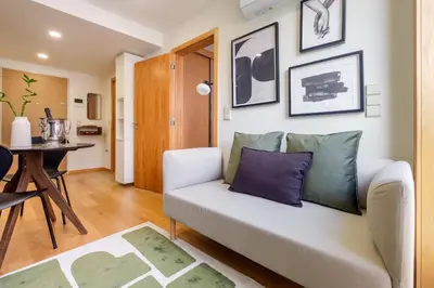 a living room with a couch and a table at Camoes Apartment with AC near Metro in Porto