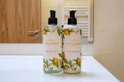 two bottles of shampoo sitting on top of a counter at Camoes Apartment with AC near Metro in Porto