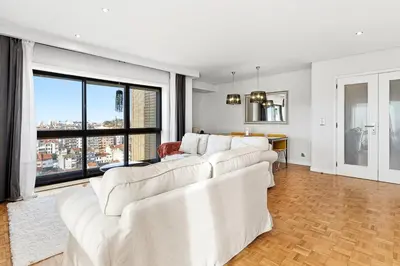 a living room with white furniture and a large window at GuestReady - Cosy Porto retreat in Porto
