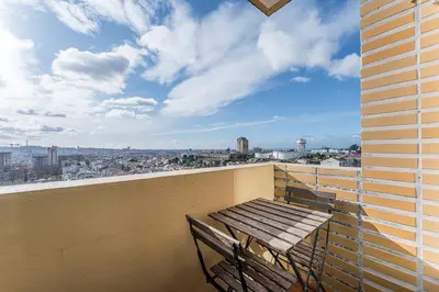 a bench on a balcony with a view of a city at GuestReady - Cosy Porto retreat in Porto