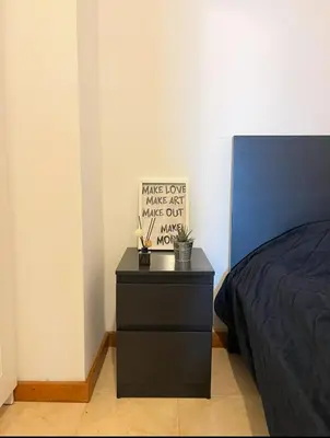 a bedroom with a bed and a black dresser at Quarto no centro do Porto in Porto