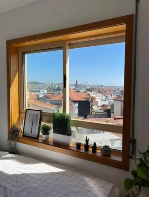 a window with a view of a city at Quarto grande no centro do Porto in Porto