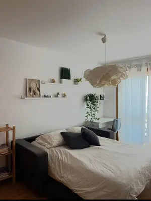a bedroom with a bed with pillows on it at Quarto grande no centro do Porto in Porto