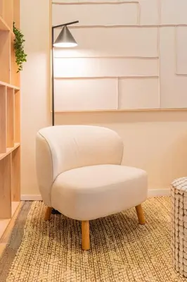 a white chair sitting on a rug in a room at Douro Prestige Studio in Vila Nova de Gaia