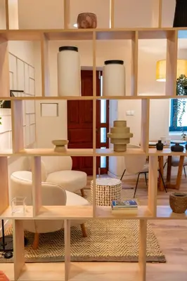 a room with a book shelf with vases on it at Douro Prestige Studio in Vila Nova de Gaia