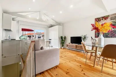 a kitchen and living room with a table and a couch at Magnolia 6 Luxury with AC Metro Downtown Porto in Porto