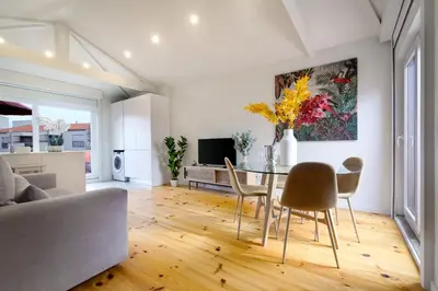 a living room with a table and chairs at Magnolia 6 Luxury with AC Metro Downtown Porto in Porto